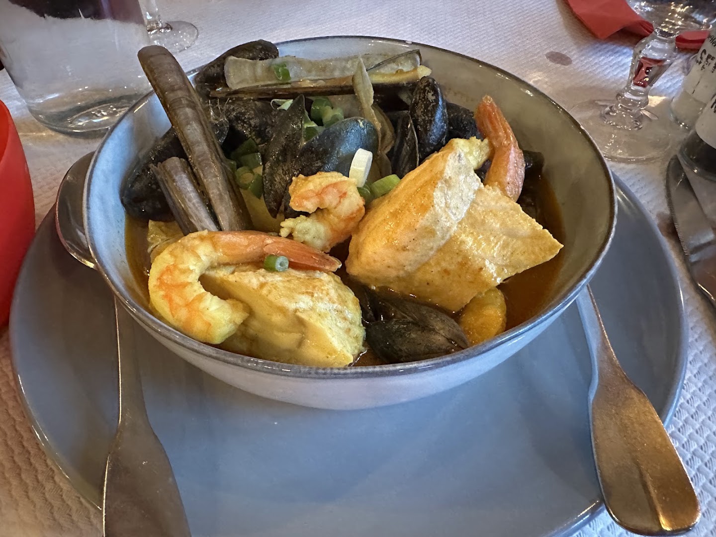 Fish, prawns and shellfish served in a metal pot